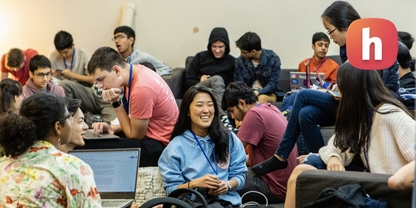 Hackathon crowd with Hack Club logo